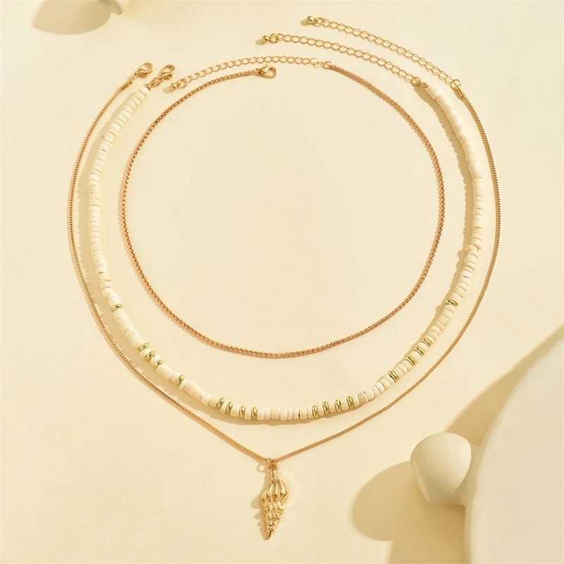 Multi layer shell and gold chain necklace