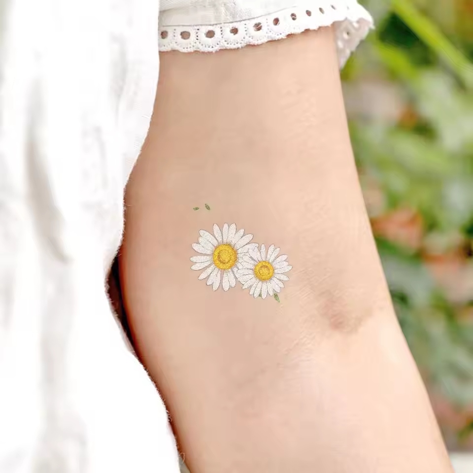 Daisy tattoos carry a wealth of meaning and symbolism.